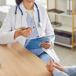 Doctor or medical professional consulting with a person about a child abuse report in Oakland County, MI