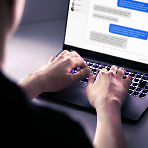 A person typing on a laptop, with a chat conversation on the screen, illustrating an Internet Solicitation accusation